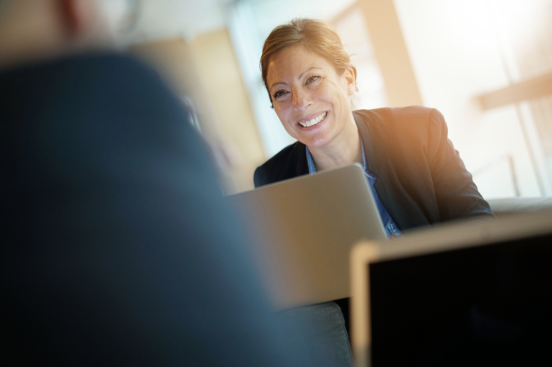 female smiling at coworker