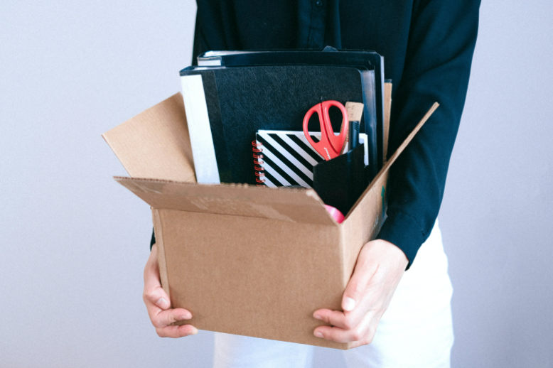 female holding office supplies
