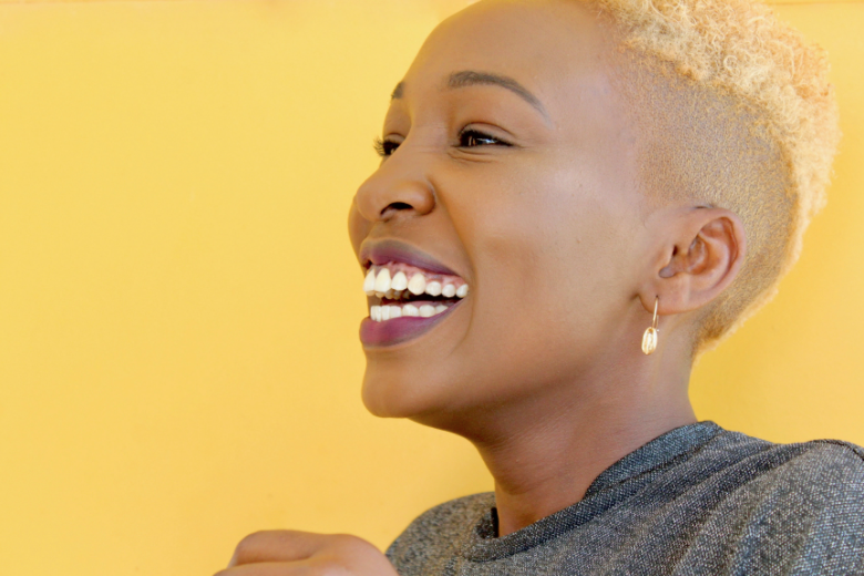 lady smiling with yellow background