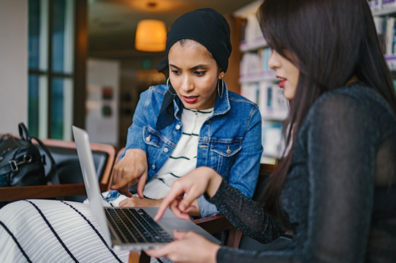 two females looking at laptop