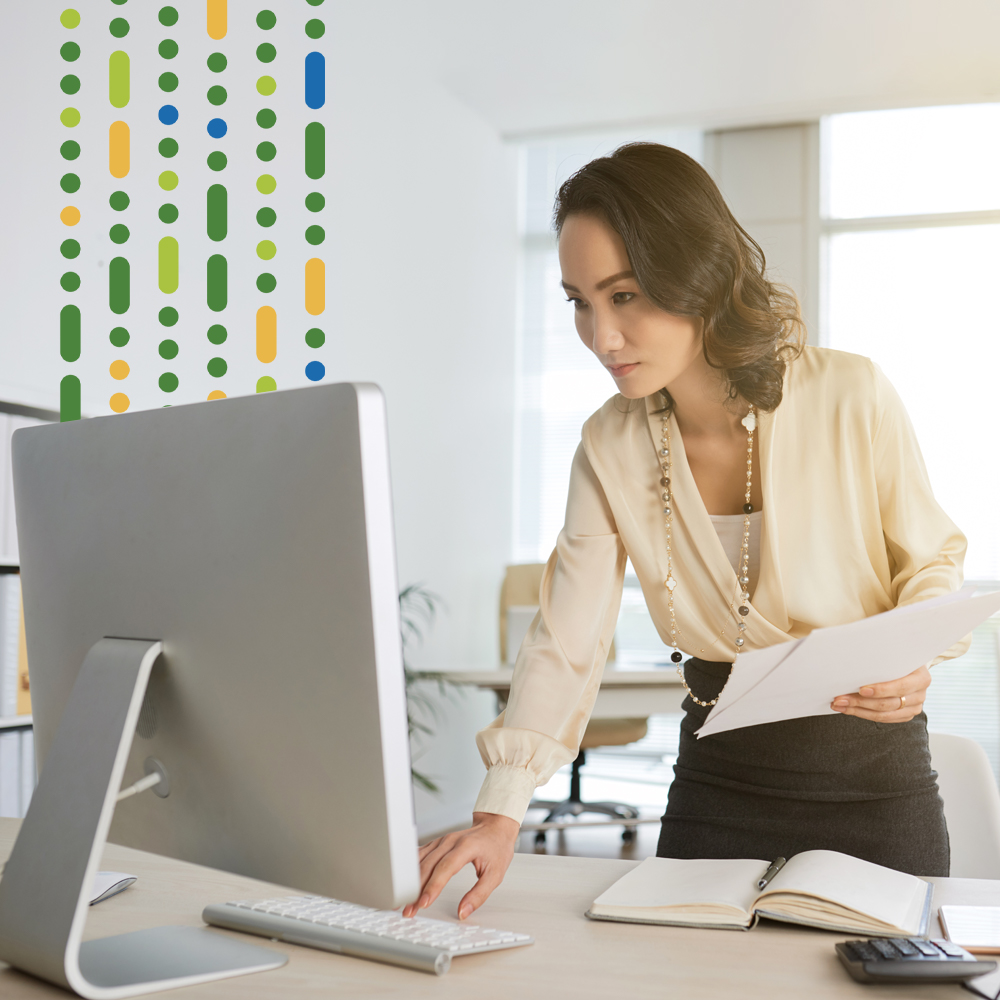 female typing on keyboard while stood up