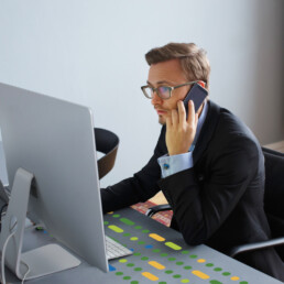 businessman on the phone looking at computer
