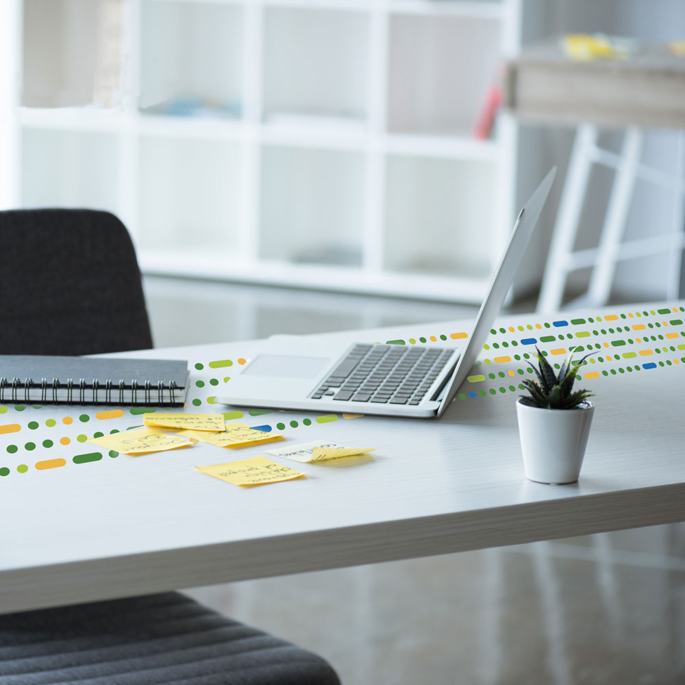 laptop on desk with sticky notes