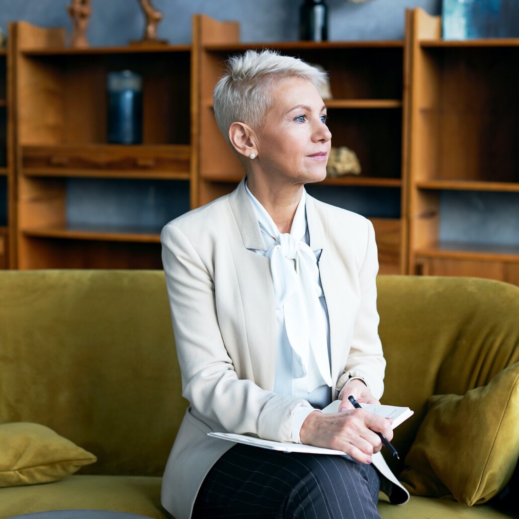 female sat on a sofa thinking