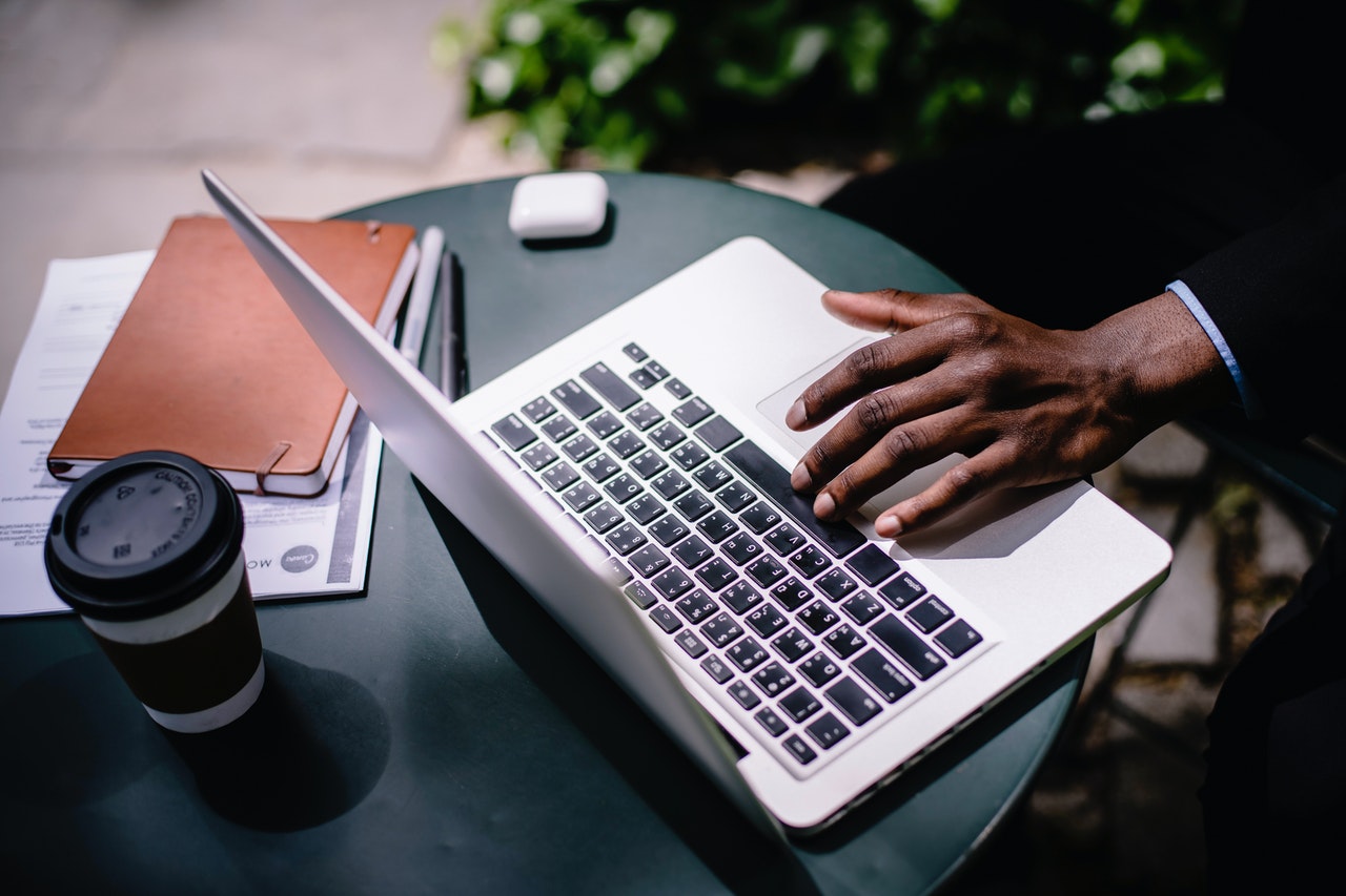 man at laptop with papers