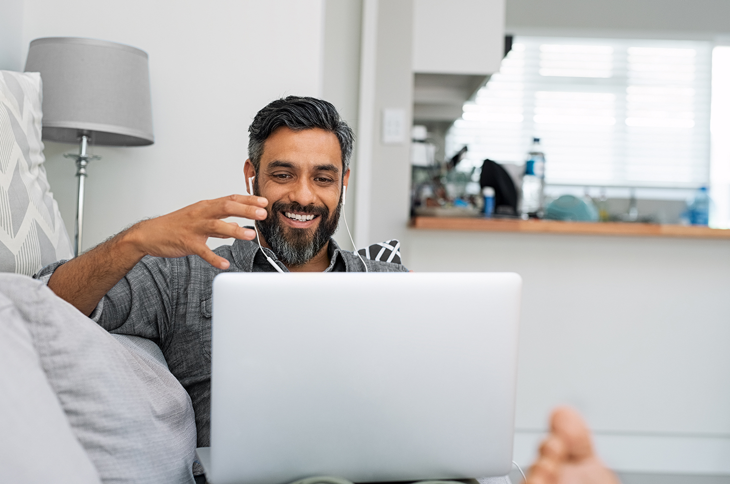 Man using laptop for video call; work from home