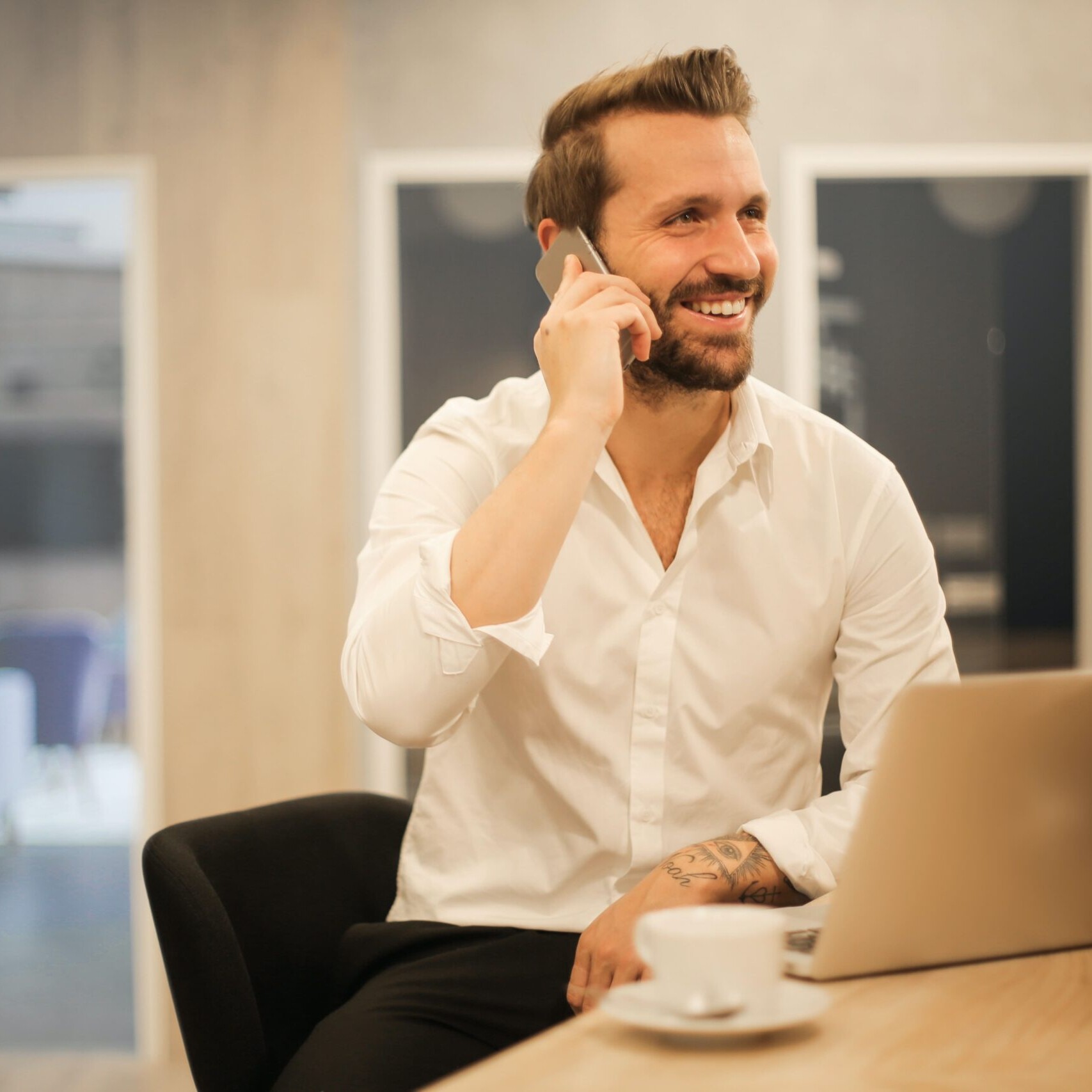 Man on phone at laptop
