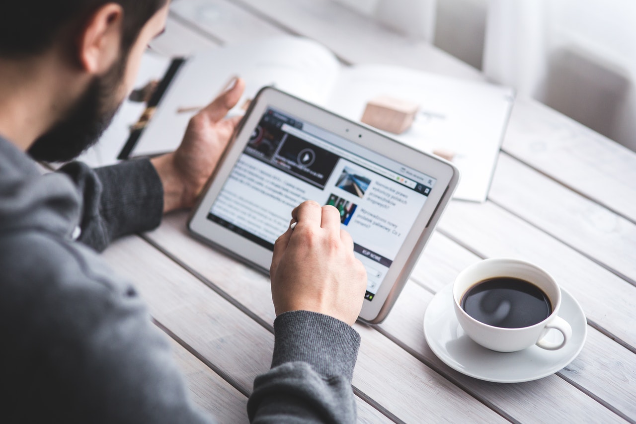 pexels-kaboompics-com-6335_ Industry-Focused News man reading news on tablet