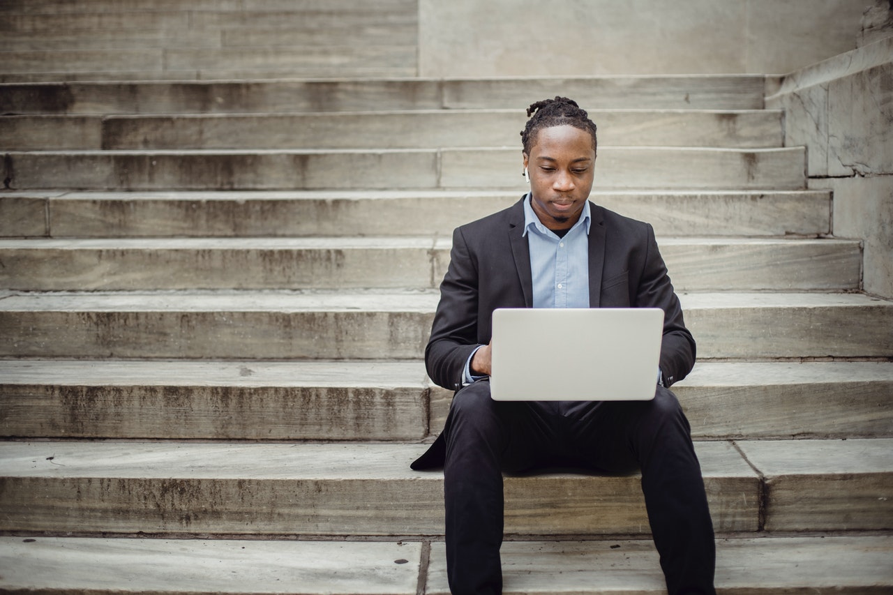 businessman sitting on stairs; sales development