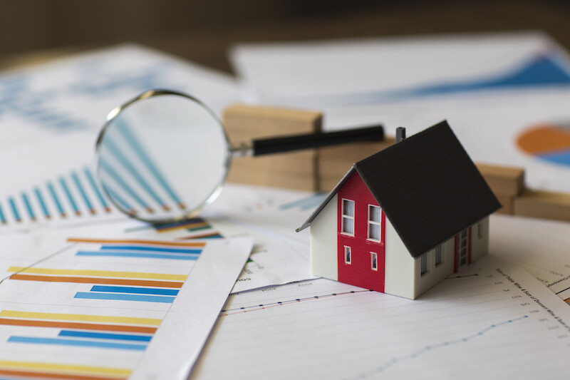 Paper house with a magnifying glass