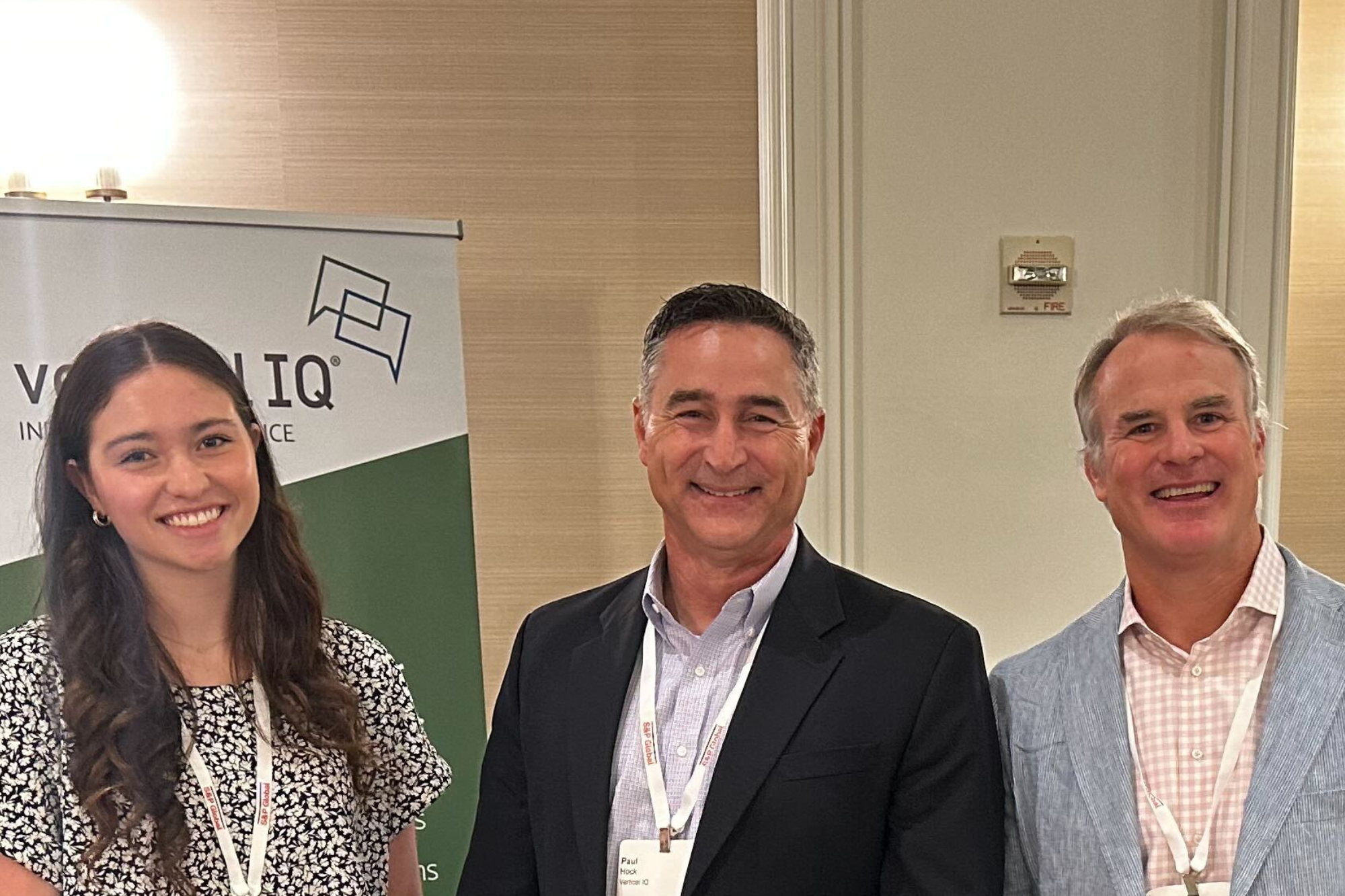 Three Vertical IQ employees smiling at the S&P Community Bankers Conference