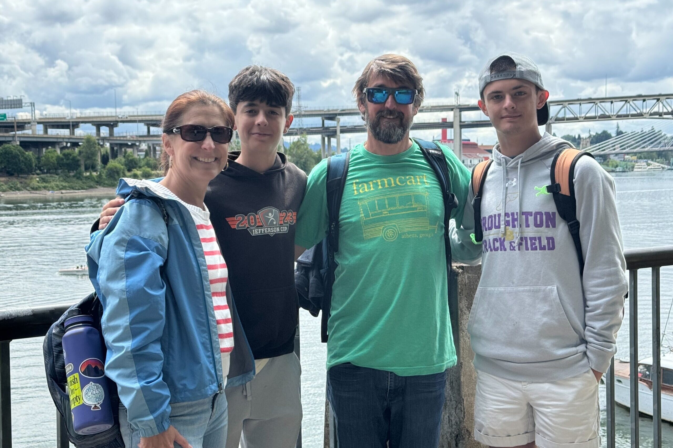 Family of four standing in front of a body of water in Portland Oregon
