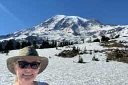 Woman standing in front of snowy mountains