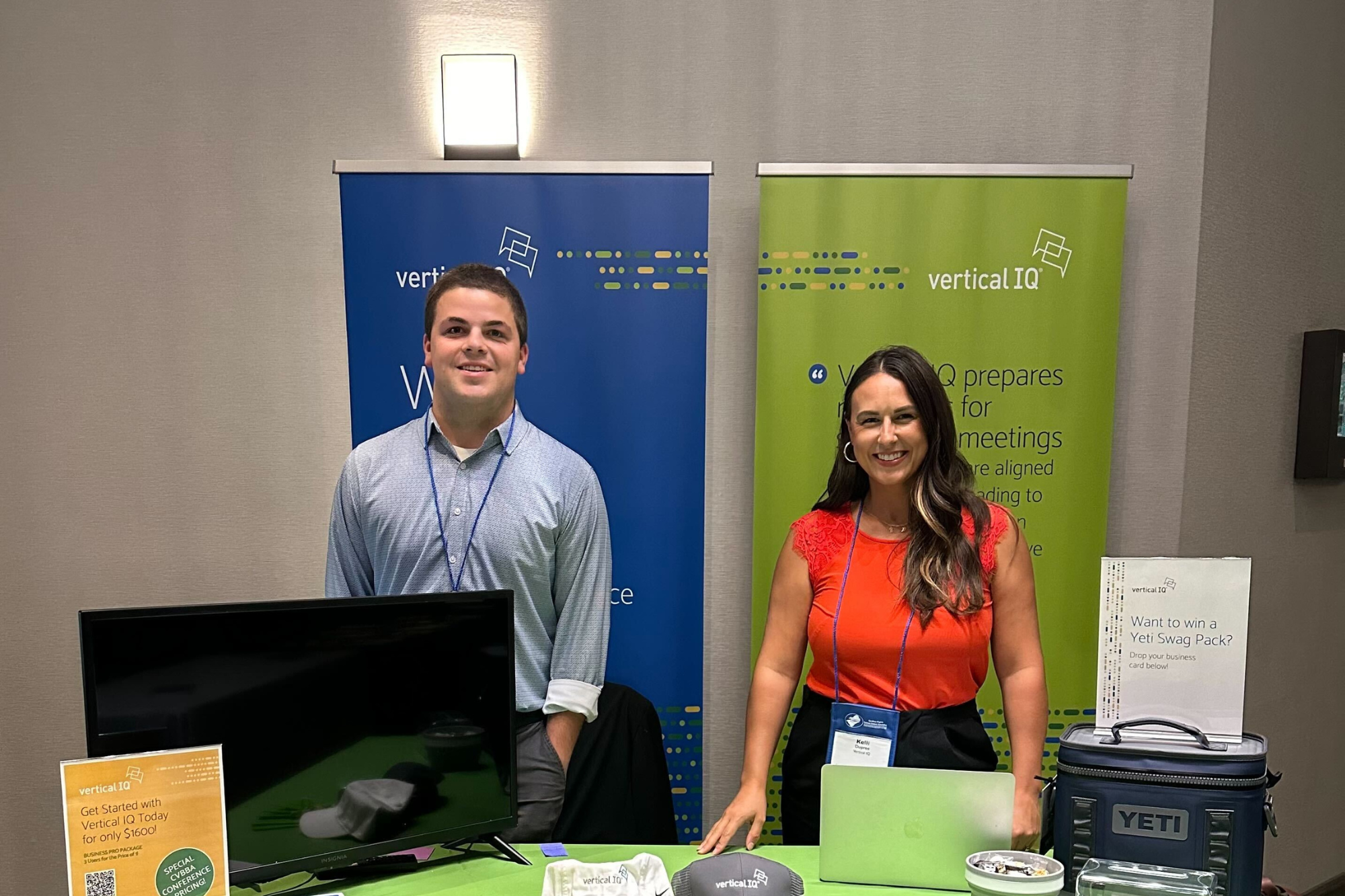 Mam and woman standing side by side at CVBBA conference at the Vertical IQ booth