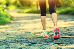 Woman running outside on a trail