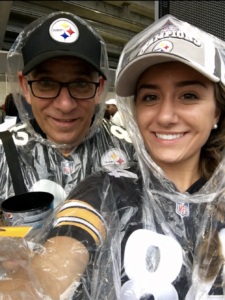 Father and Daughter at a Steelers football game wearing steelers merch