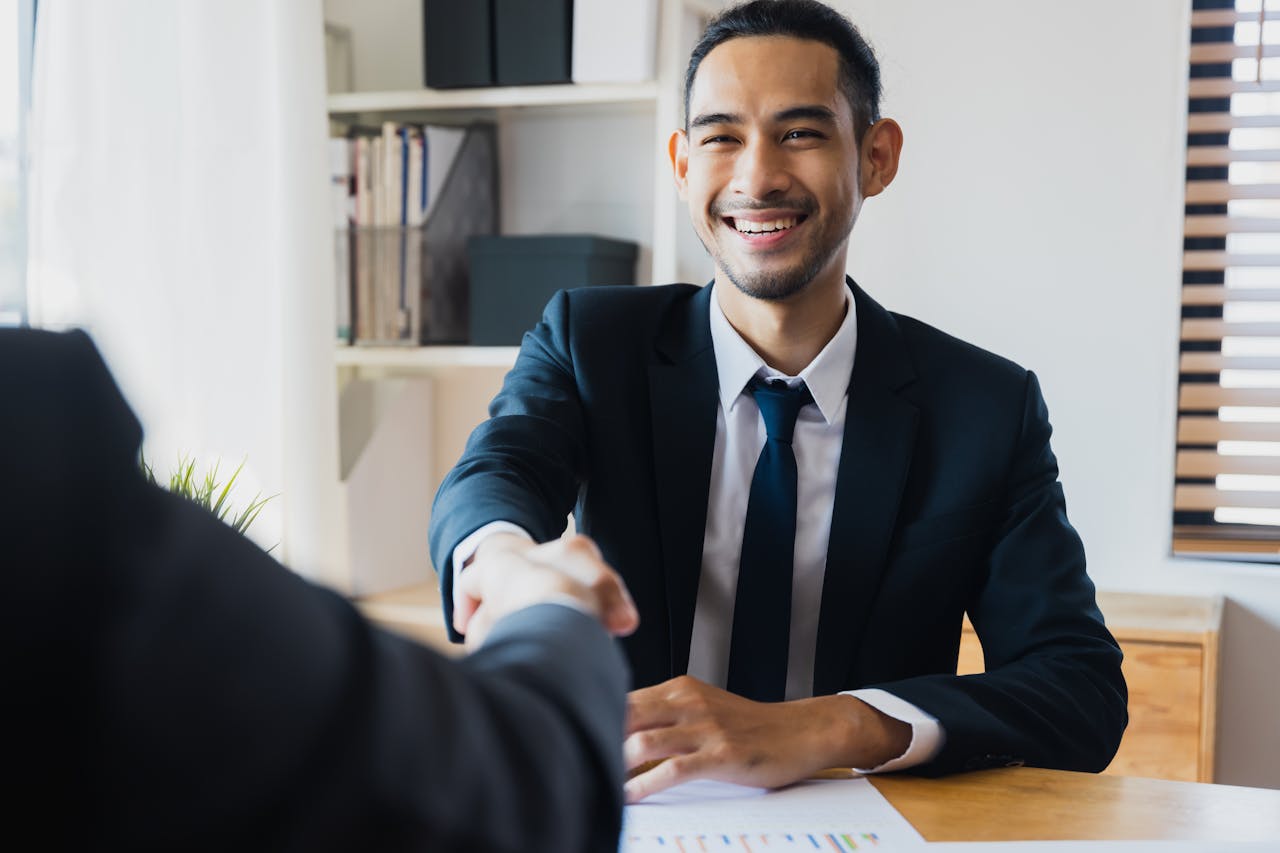 pexels-khwanchai-12885861; banker and client shaking hands