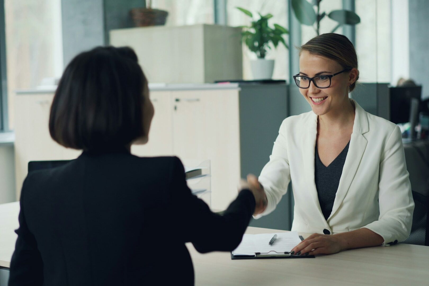 two business women shaking hands