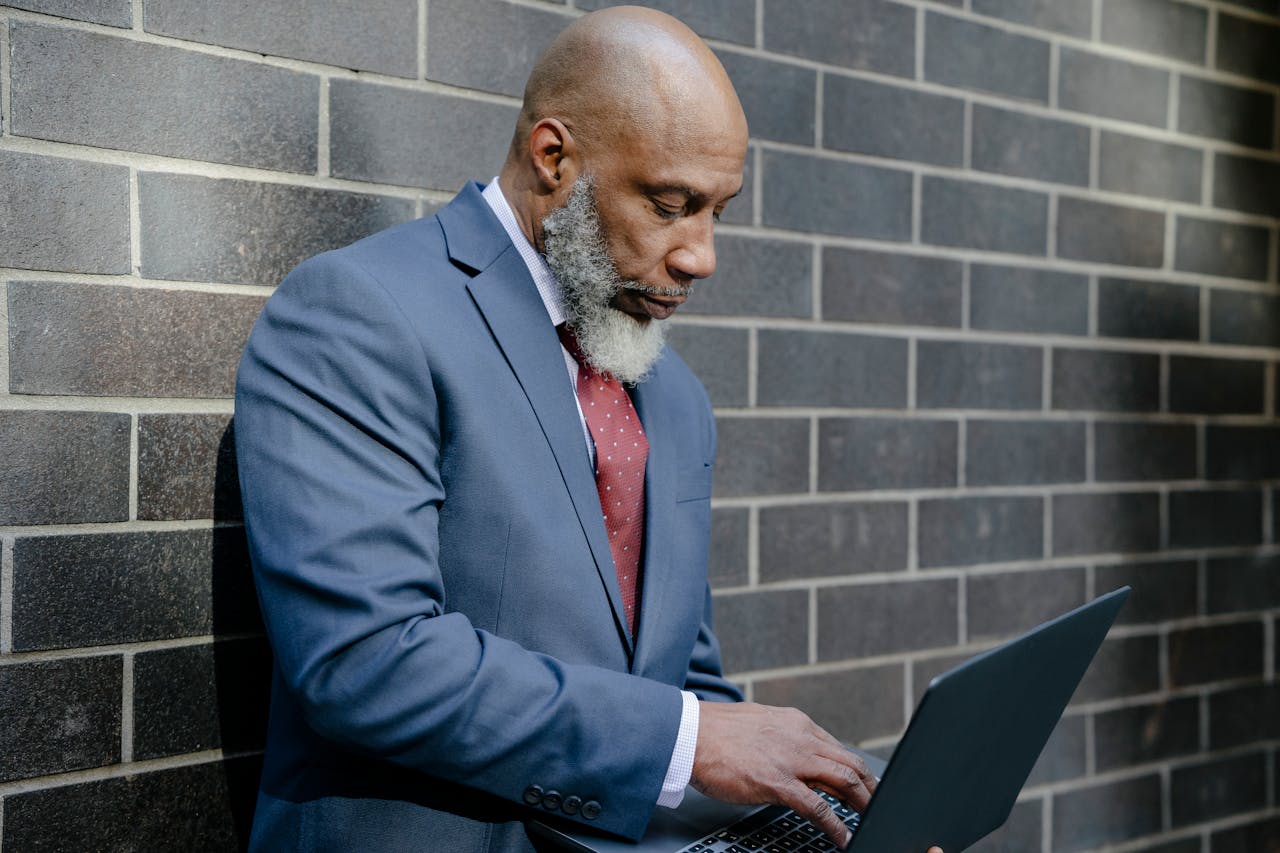 experienced banker looking at a laptop computer